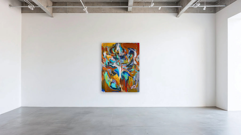 An abstract canvas painting by Ethan Newman with vibrant orange, blue, yellow, and green brushstrokes, displayed on a white gallery wall in a modern studio with concrete floors.